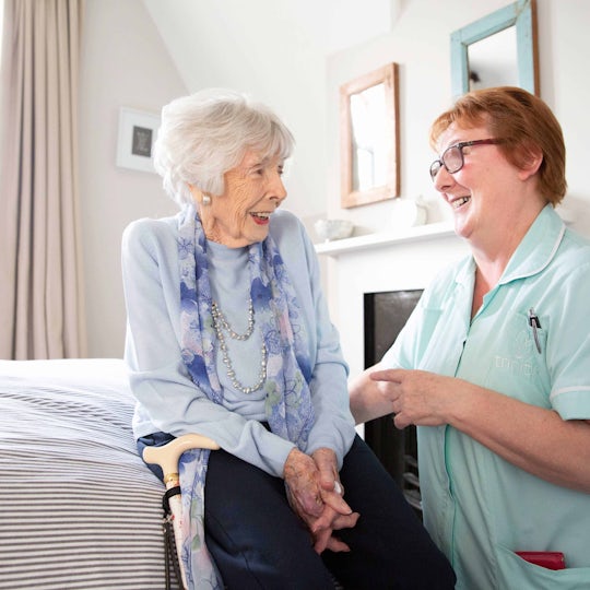 Our Trinity Carer assisting an elderly lady