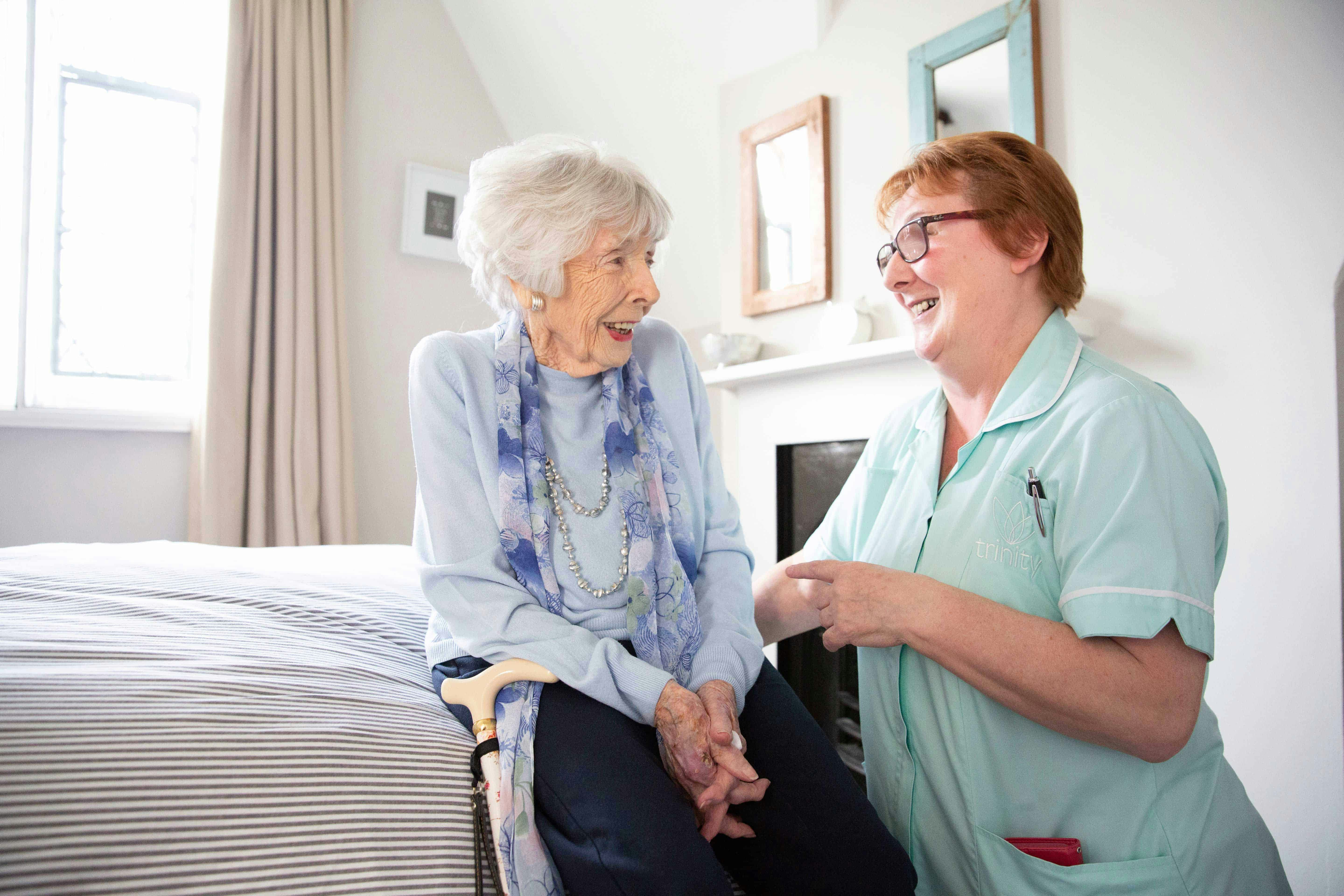 Our Trinity Carer assisting an elderly lady in the winter months