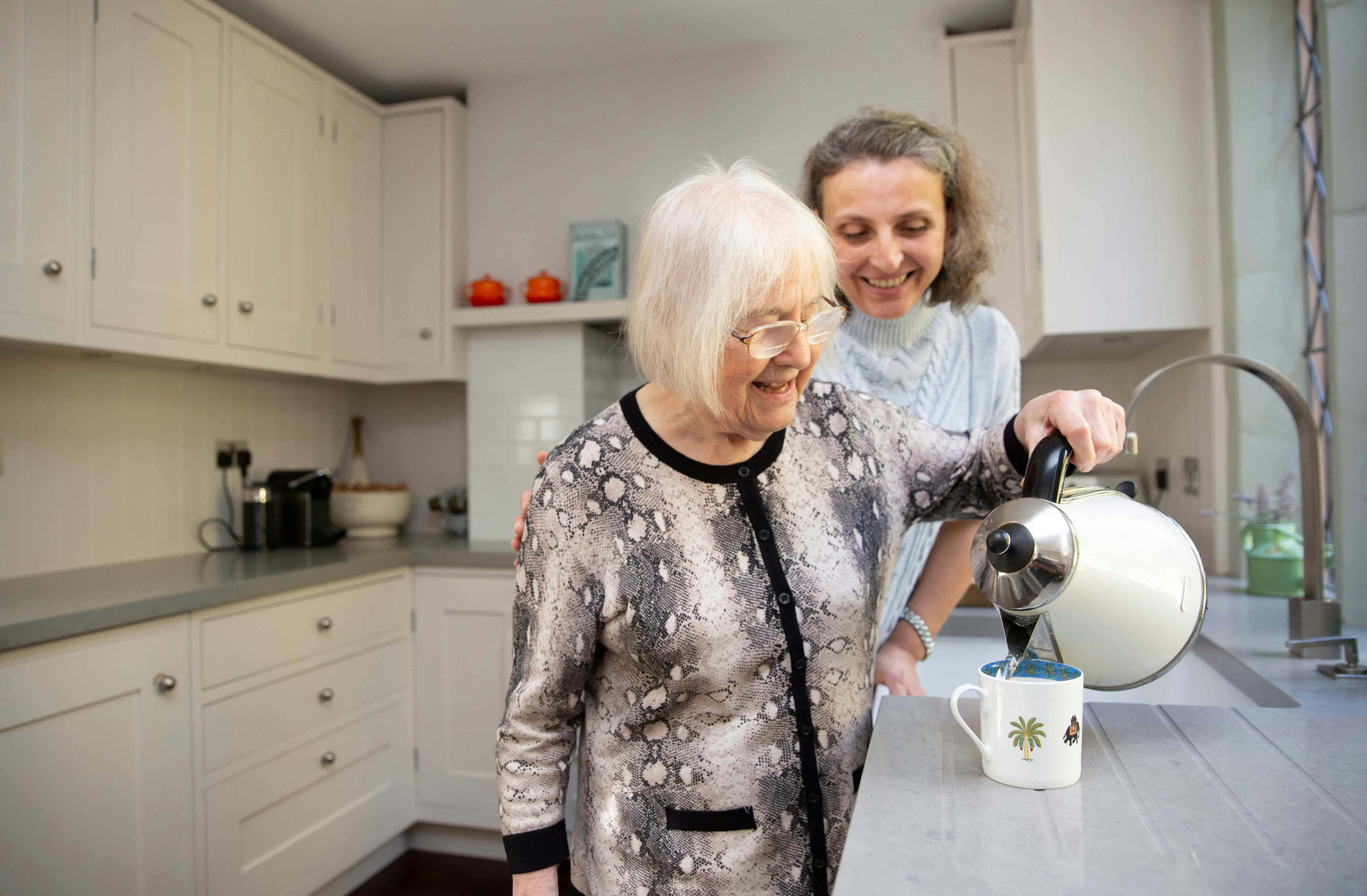 Dementia patient pouring a cup of tea