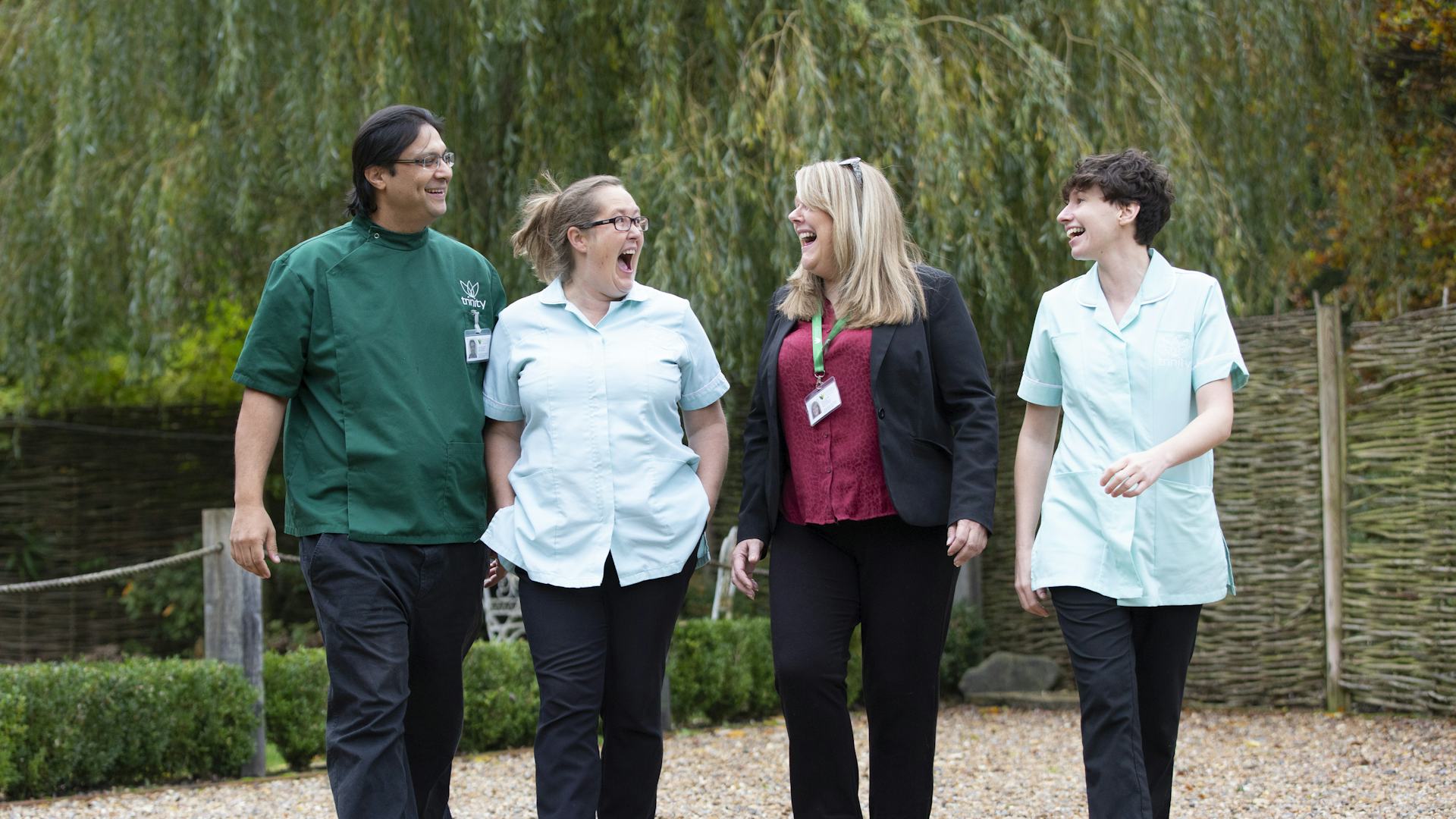 Four Trinity Homecare carers walking side by side