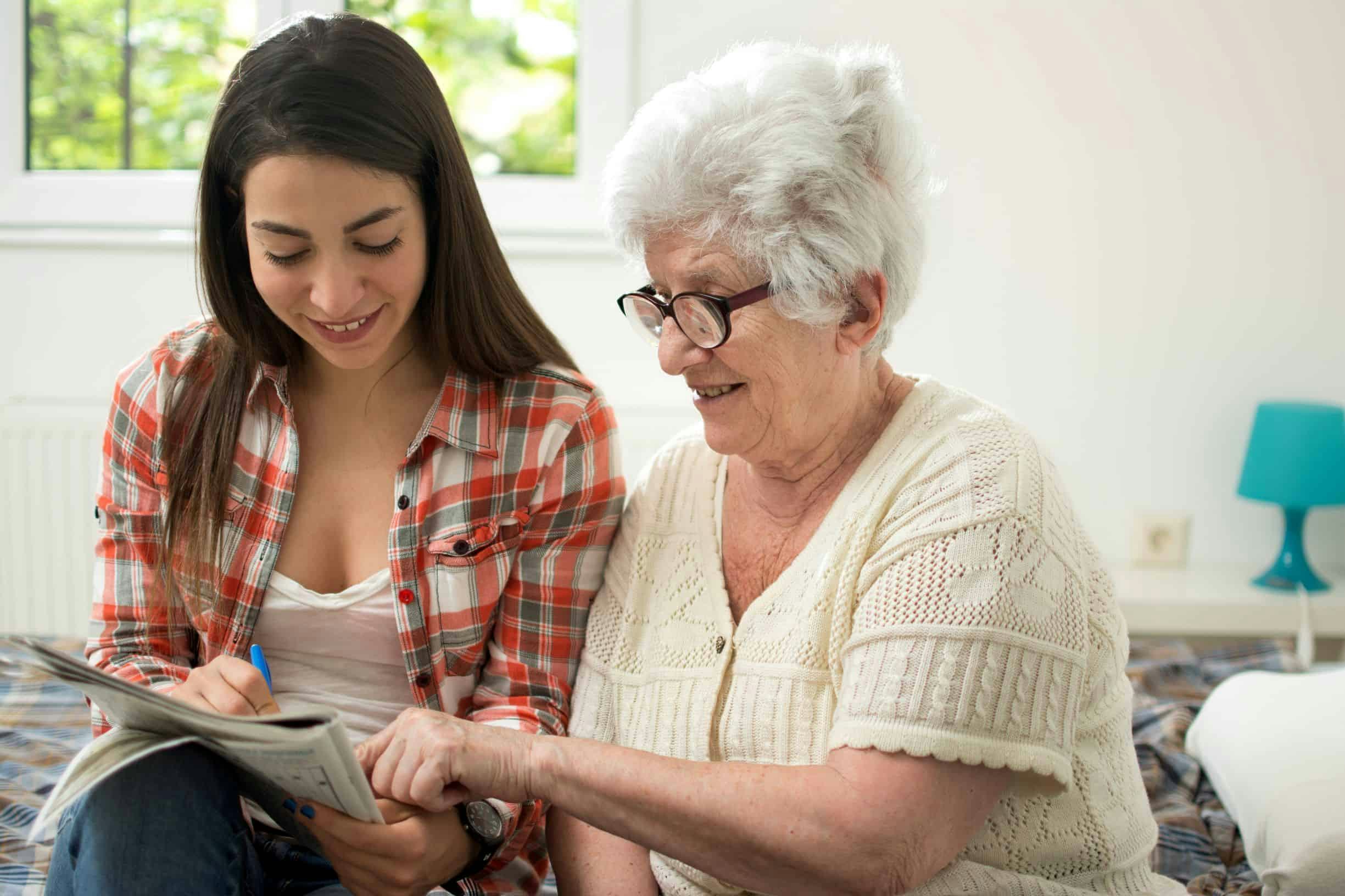 A dementia patient doing a puzzle with a friend