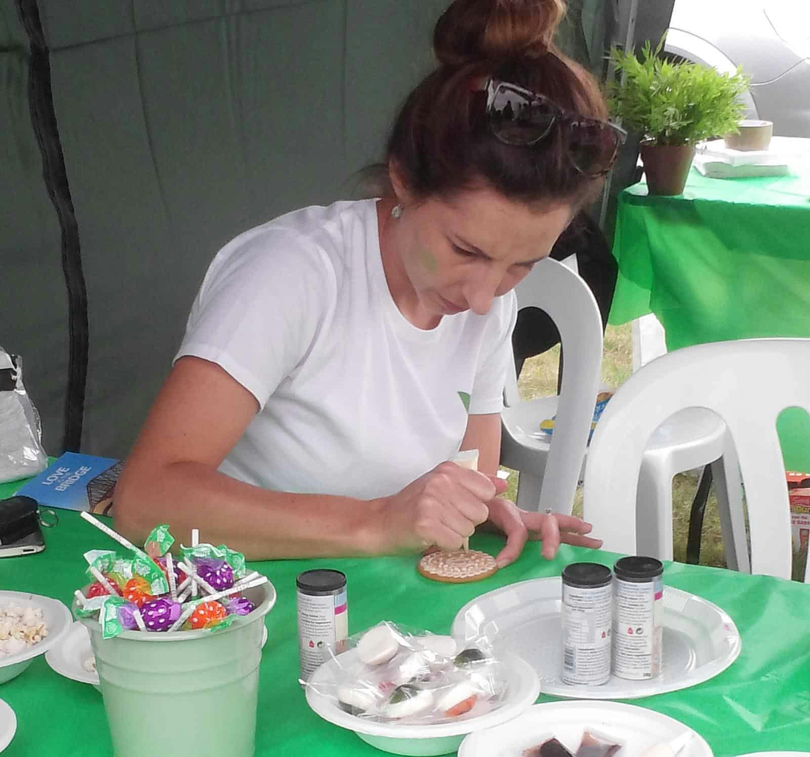 Marissa Esterhuysen Live-in Care service Manager icing biscuits at the Epsom and Ewell Fun Day