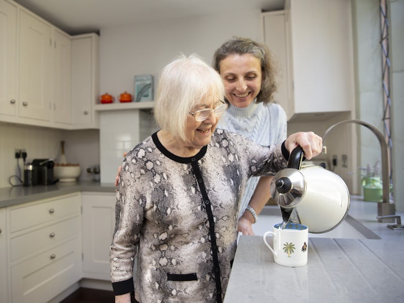 Elderly Lady with Kettle being supported by her Carer