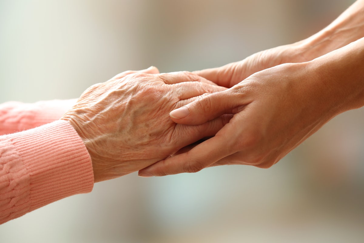 Young hands holding elderly hands