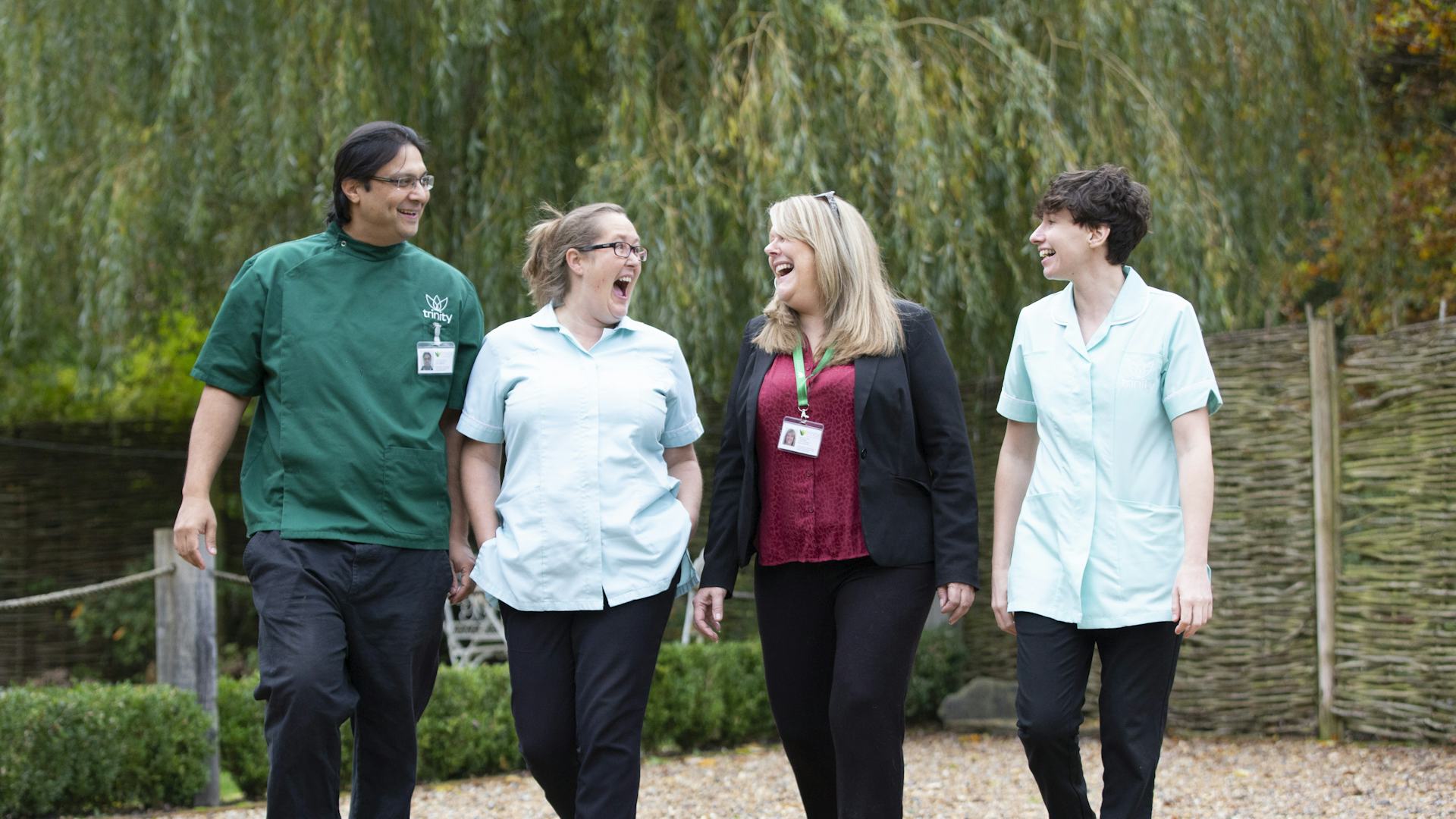 Three carers and a care manager walking together