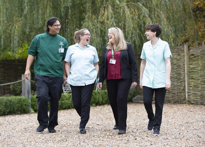 Three carers and a care manager walking together